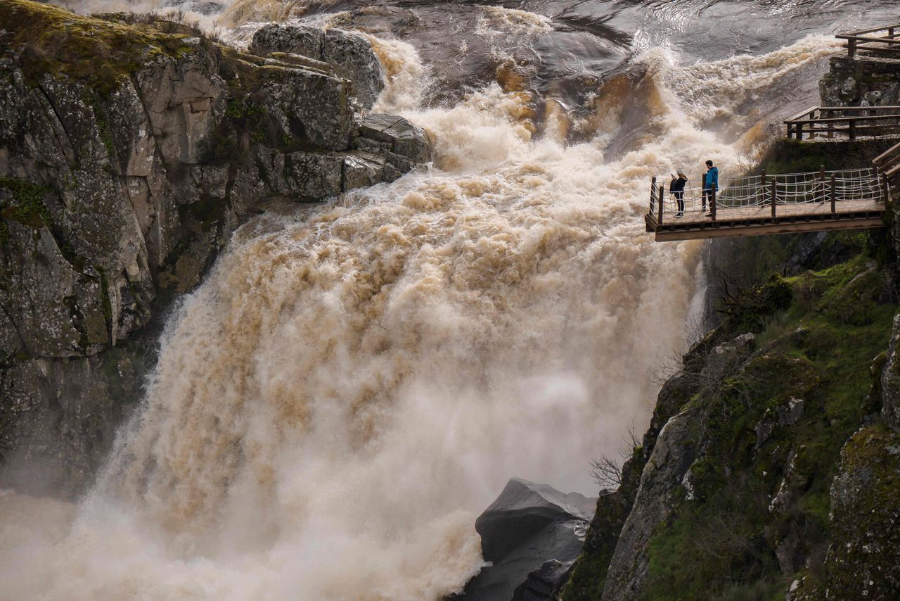 Vanaf een platform kijken mensen uit op een waterval in de Uces, een rivier in de Spaanse provincie Salamanca, afgelopen woensdag. Het peil in de rivier staat op een zeer hoog niveau.