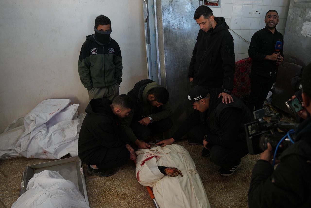 Palestijnen rouwen bij het lichaam van Mohammed al-Hawli tijdens zijn begrafenis in het Al-Aqsa-ziekenhuis in Deir al-Balah, op vrijdag 16 januari 2026. Al-Hawli kwam door een Israëlische aanval om het leven.