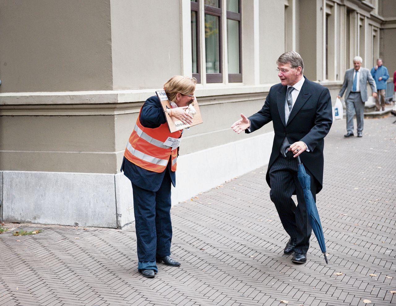 Piet Hein Donner schudt de hand van beroepsdemonstrant Elise Leijten (1962 - 2018) op Prinsjesdag 2011.