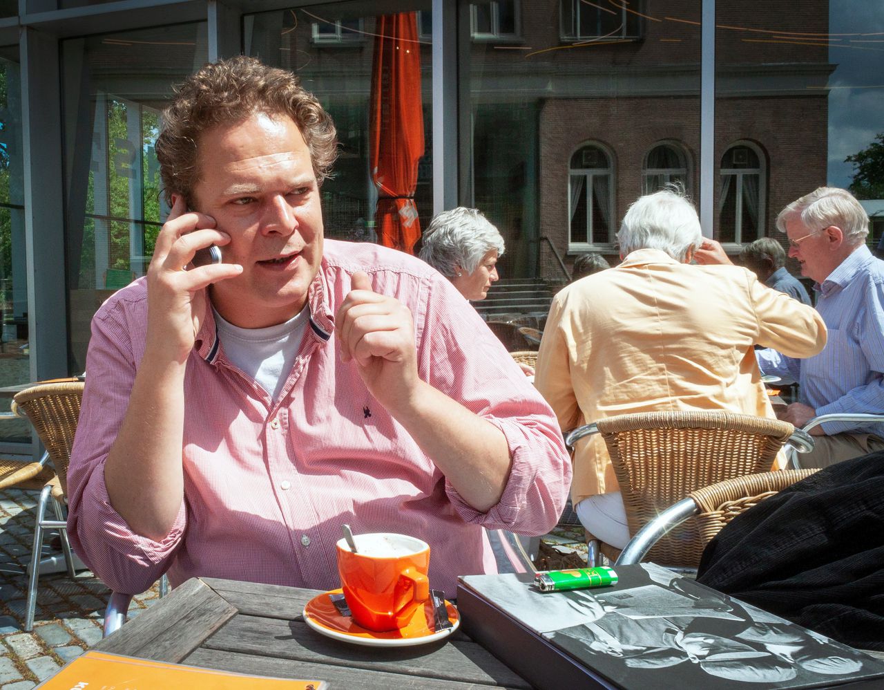 Journalist Mark Hoogstad in juni 2011, telefonerend op het terras van de Rotterdamse Kunsthal.