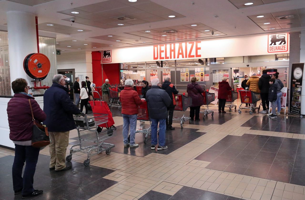 Ouderen in de rij voor een Delhaize supermarkt in Brussel. De winkel ging een uur eerder open voor 65-plussers.