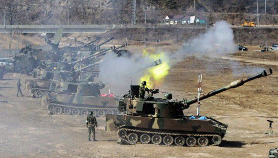Howitzers from the South Korean army participate in a live-firing drill during the annual Foal Eagle Exercise, a joint maneuver between South Korea and the U.S., near Rodriguez Range in Pocheon, south of the demilitarized zone that divides the two Koreas, in this March 15, 2012 file photo. South Korea's military said it will strike back at North Korea and target its top leadership if Pyongyang launches a threatened attack in response to what it says are "hostile" drills between U.S. and South Korean forces. One of North Korea's top generals, in a rare appearance on state television on March 5, 2013 said Pyongyang had torn up its armistice deal with Washington and threatened military action against the U.S. and South Korea if the drills went ahead. The military exercises began on March 1. REUTERS/Ahn Young-joon/Pool/Files (SOUTH KOREA - Tags: POLITICS MILITARY)