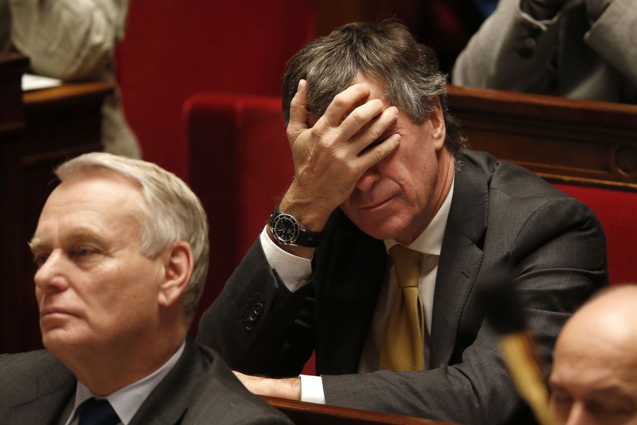 French Junior Minister for Budget Jerome Cahuzac (R) and Prime Minister Jean-Marc Ayrault attend the questions to the government session at the National Assembly in Paris in this December 11, 2012 file picture. French prosecutors opened a formal tax fraud investigation on Tuesday March 19, 2013 into allegations that Budget Minister Jerome Cahuzac held a secret bank account in Switzerland. Picture taken December 11, 2012. REUTERS/Charles Platiau/Files (FRANCE - Tags: POLITICS)
