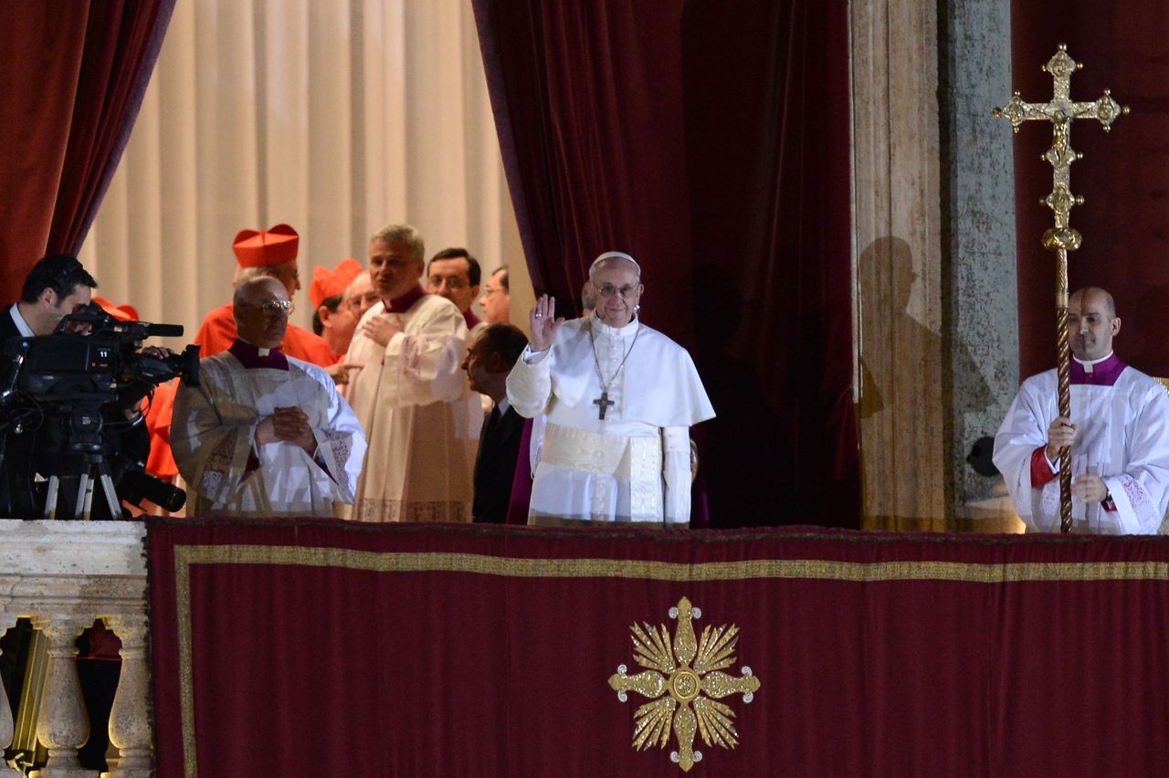 New Pope, Argentinian cardinal Jorge Mario Bergoglio appears at the window of St Peter's Basilica's balcony after being elected the 266th pope of the Roman Catholic Church on March 13, 2013 at the Vatican. AFP PHOTO / FILIPPO MONTEFORTE