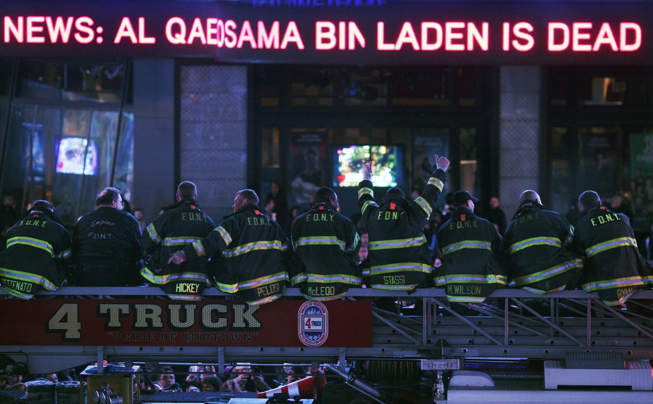 Firefighters react in Times Square after President Barack Obama announced that the United States has the body of Osama bin Laden, in New York, May 1, 2011. Bin Laden, the mastermind of the most devastating attack on American soil in modern times and the most hunted man in the world, was killed in a firefight with United States forces in Pakistan on Sunday, President Obama announced. (Michael Appleton/The New York Times)