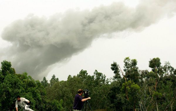 A picture taken from the roof of the hotel where foreign journalists reside in Tripoli on June 7, 2011 shows smoke billowing across an area in which strongman Moamer Kadhafi has his residence, following four explosions that shook the centre of the Libyan capital. AFP PHOTO/MAHMUD TURKIA