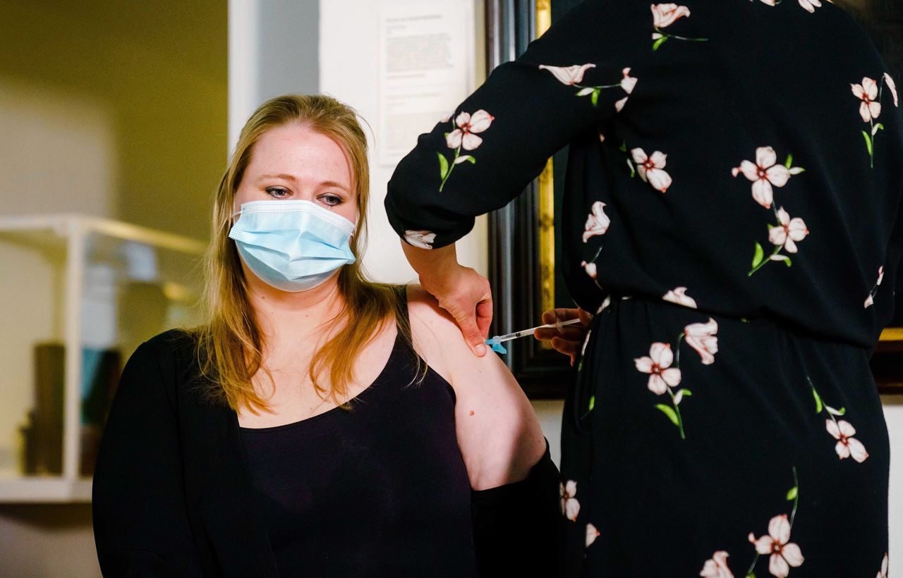 Een arts dient in Museum Boerhaave ggz-medewerker Babette Engelsman de eerste prik met het Janssen-vaccin toe.
