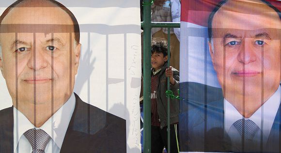 Caption: A boy stands between posters of Yemen's Vice President Abd Rabbu Mansour Hadi during an election rally in Sanaa February 20, 2012. Yemenis head to the polls on February 21 for an election in which Hadi is the sole candidate to take over from President Ali Abdullah Saleh and steer the country during a two-year transitional period. REUTERS/Mohamed al-Sayaghi (YEMEN - Tags: POLITICS ELECTIONS)