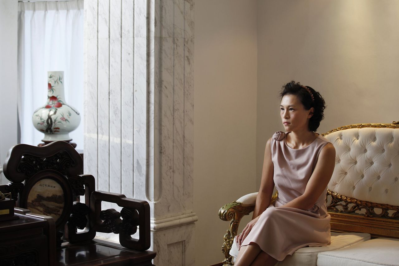 Gigi Chao, the daughter of Hong Kong property tycoon Cecil Chao Sze-tsung, poses at the conference room of her office in Hong Kong September 27, 2012. A flood of men offered dates and marriage proposals to the lesbian daughter of Cecil Chao who was willing to pay $500 million HKD ($64 million) to a successful son-in-law. Gigi, who works with her father as the executive director of the family-owned Cheuk Nang Holdings Ltd, told Reuters in an exclusive interview that she saw her father's announcement as an act of love. REUTERS/Bobby Yip (CHINA - Tags: SOCIETY BUSINESS)