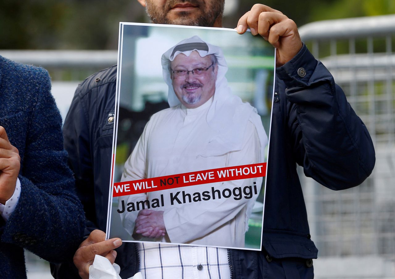 Iemand houdt een foto omhoog van de Saoedische journalist Jamal Khashoggi bij een protest voor het Saoedische consulaat.
