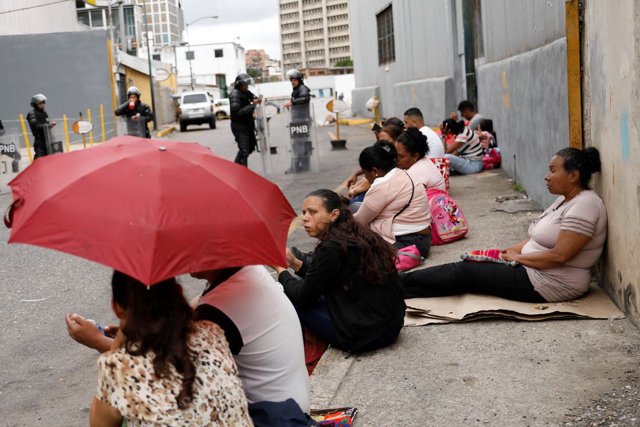 Familieleden wachten bij de gevangenis in Caracas, met wc-papier en maiskoekjes 