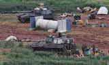Israeli army soldiers stand next to a self-propelled Howitzer artillery gun positioned in the upper Galilee in northern Israel near the border with southern Lebanon on March 29, 2026. Lebanon was drawn into the Middle East war on March 2, when pro-Iran Hezbollah launched rockets towards Israel in response to US-Israeli strikes that killed Iranian supreme leader on February 28. (Photo by Jalaa MAREY / AFP) / 