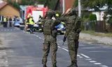 Poolse militairen en hulpdiensten zijn paraat nadat een Russische drone schade aanrichtte aan het dak van een woning in Wyryki, in het oosten van het land. Foto WOJTEK JARGILO/EPA