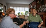 Home care worker Linda Vermeer talks to Lex, 90, in his home in Rozenburg.