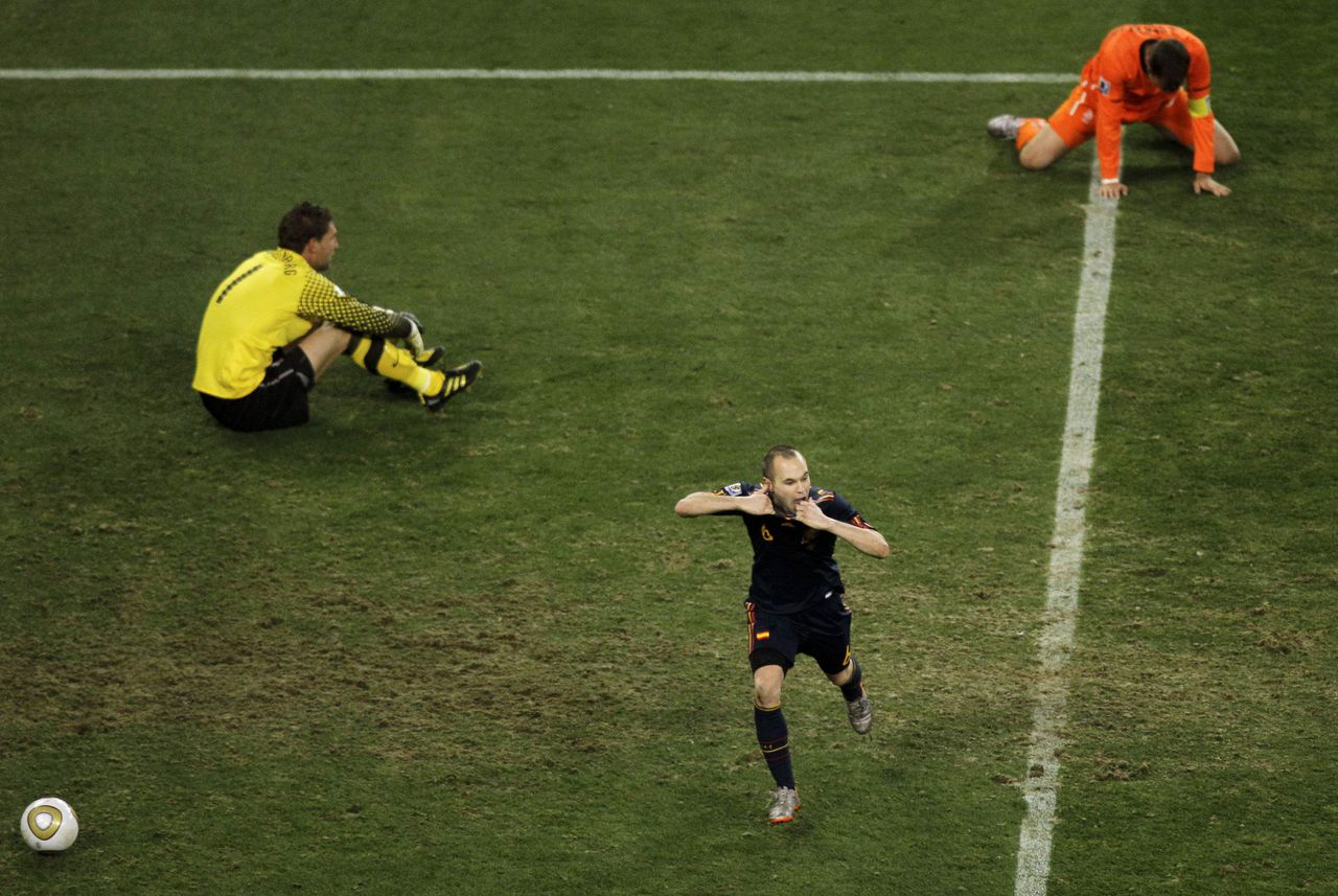 Spain's Andres Iniesta, center, celebrates after scoring the decisive goal past Netherlands goalkeeper Maarten Stekelenburg, left, during the World Cup final soccer match between the Netherlands and Spain at Soccer City in Johannesburg, South Africa, Sunday, July 11, 2010. (AP Photo/Hassan Ammar)