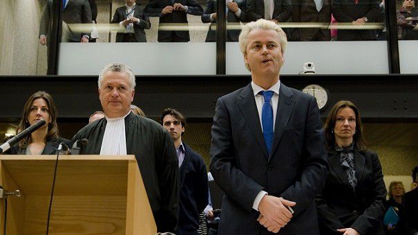 The Dutch anti-Islam lawmaker Geert Wilders, right, and his lawyer Bram Moszkowicz, left, returned to court in Amsterdam, Netherlands, Monday Feb 7, 2011, as a second set of judges considered how his trial for alleged hate speech should continue. He faces charges for remarks including comparing Islam to Nazism and calling for a ban on the Quran. Wilders has risen to a position of power, propping up a minority conservative Cabinet, on a platform of demanding an immigration freeze and blunt measures forcing Muslim immigrants to integrate. (AP Photo/Robin van Lonkhuijsen, POOL)