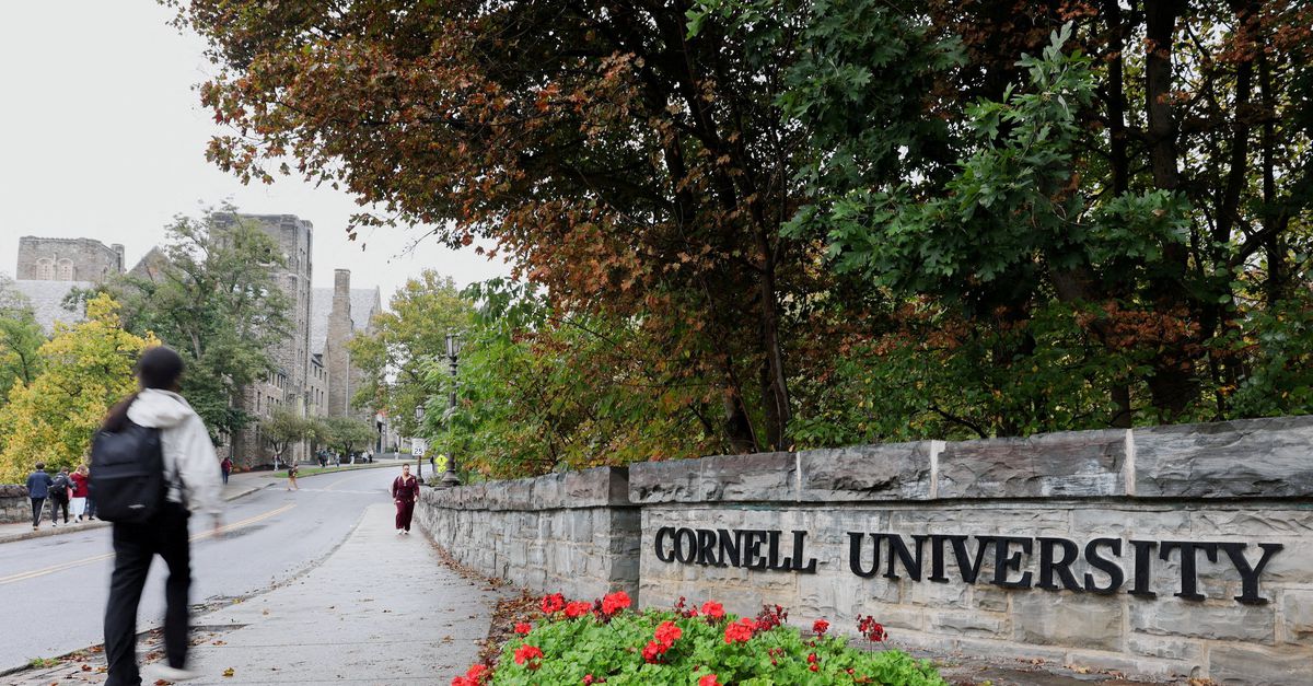 FILE PHOTO: A student walks by a sign at the entrance of Cornell University in Ithaca, New York, US, October 1, 2026