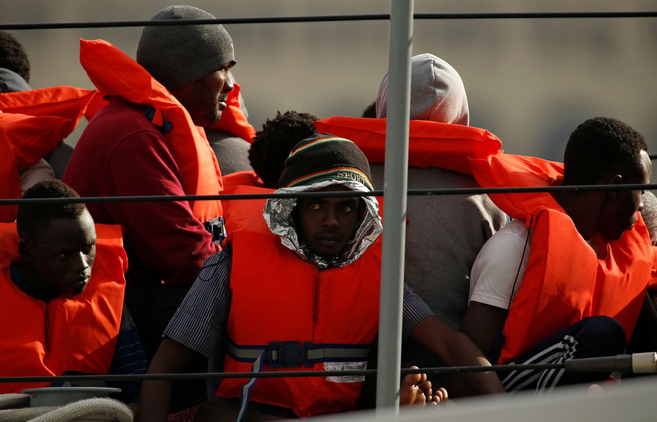 De opgepikte migranten op een patrouilleboot, kort voor ze aan wal gingen bij de Maltese haven Marsamxett.