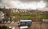 A view from the roof of the UNRWA Girls School in Jalazoun above the separation wall and the olive grove towards the Israeli settlement of Beit El. 