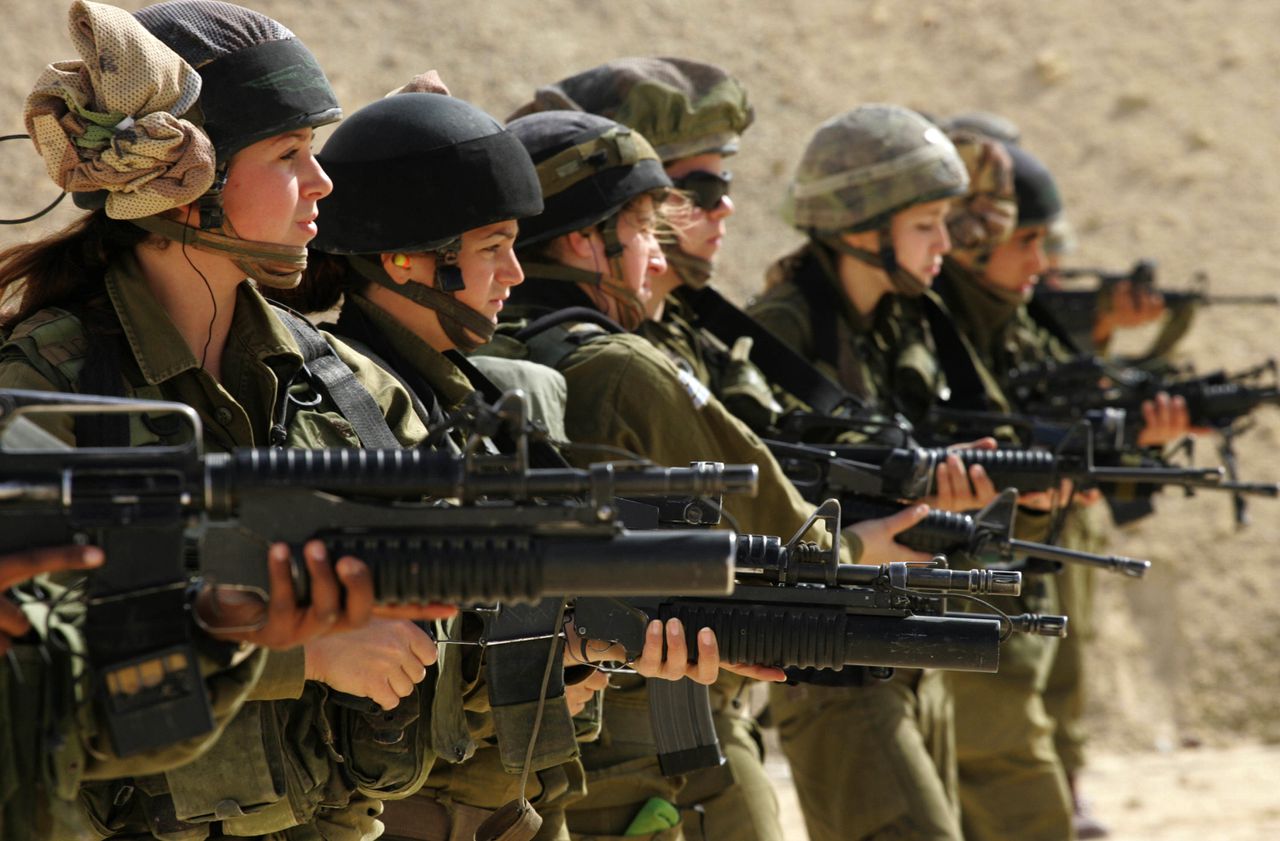 Female Israeli combat soldiers of the Caracal light infantry Battalion hold up their M-16 rifles at a shooting range in Ein Yahav, southern Israel, 13 February 2007. The Caracal Battalion is a combat battalion of the Israeli army and is composed of both male and female soldiers. Women were previously prevented from serving in direct combat positions, but due to growing public pressure, the Caracal unit was formed in 2000, and was assigned patrols along the Israel-Jordan border. AFP PHOTO/GALI TIBBON