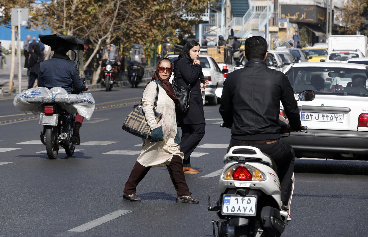 Twee vrouwen steken over in Teheran op 9 november. Sinds 1979 hebben de religieuze leiders altijd vastgehouden aan het dragen van de hijab, al was het toezicht daarop niet steeds even streng.