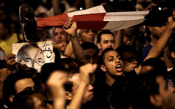 Caption: The revolutionary youth of Egypt return to Tahrir to protest the outcome of the Egyptian presidential election, Cairo, Egypt, Monday May 28, 2012. The runoff vote for Egypt's next president will pit the Muslim Brotherhood's candidate against the last prime minister to serve under Hosni Mubarak, according to full official results released Monday by the election commission. Commission chief Farouq Sultan told a news conference that the Brotherhood's Mohammed Morsi and Ahmed Shafiq, a former air force commander and a longtime friend of the ousted leader, were the top two finishers in the first round of voting held on May 23-24. (AP Photo/Fredrik Persson)