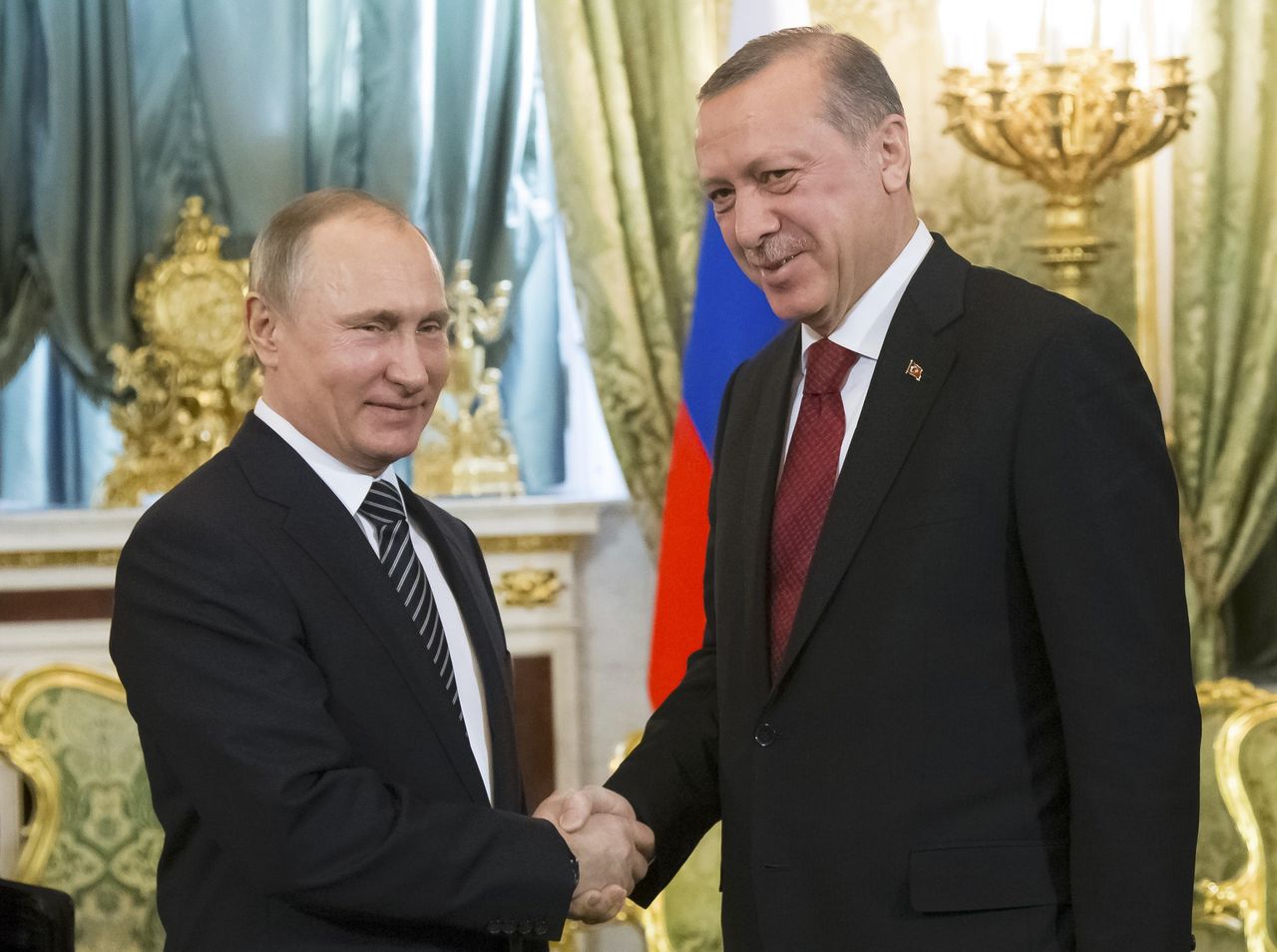 Vladimir Poetin en Tayyip Erdogan schudden handen tijdens een ontmoeting in Moskou op 10 maart 2017.