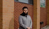 At the exit of the Islamic Center of Detroit, Mahmoud Muheisen hands out brochures with the call to vote Trump nor Harris.