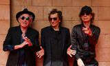 Keith Richards, Ronnie Wood en Mick Jagger kort voor de presentatie van hun single 'Angry' in het Hackney Empire in Londen.