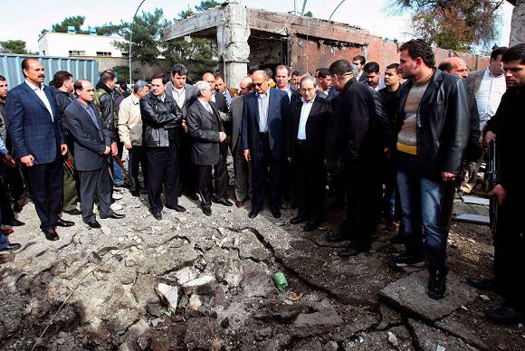 A delegation of Arab League officials visits a site to inspect damages to buildings after a car bomb attack in Damascus December 23, 2011, in this handout photograph released by Syria's national news agency SANA. Suicide car bombers struck Damacus on Friday, officials said, killing 40 people, gutting buildings and sending human limbs flying in the bloodiest violence to hit Syria's capital in a nine-month-old uprising against President Bashar al-Assad. QUALITY FROM SOURCE. REUTERS/Sana/Handout (SYRIA - Tags: CIVIL UNREST POLITICS) FOR EDITORIAL USE ONLY. NOT FOR SALE FOR MARKETING OR ADVERTISING CAMPAIGNS. THIS IMAGE HAS BEEN SUPPLIED BY A THIRD PARTY. IT IS DISTRIBUTED, EXACTLY AS RECEIVED BY REUTERS, AS A SERVICE TO CLIENTS