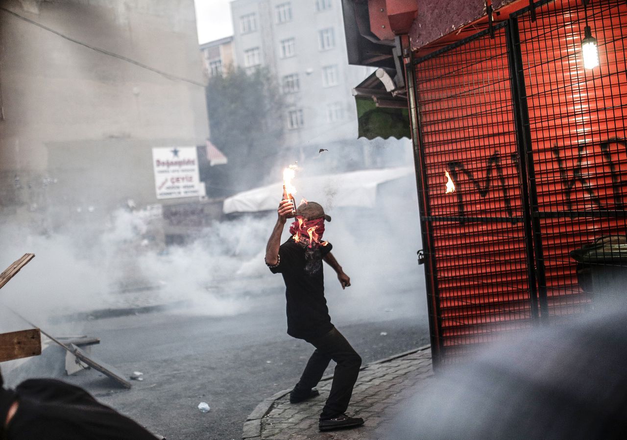 Een betoger gooit een Molotovcocktail richting de politie tijdens een betoging in de straten van Istanboel gisteravond.