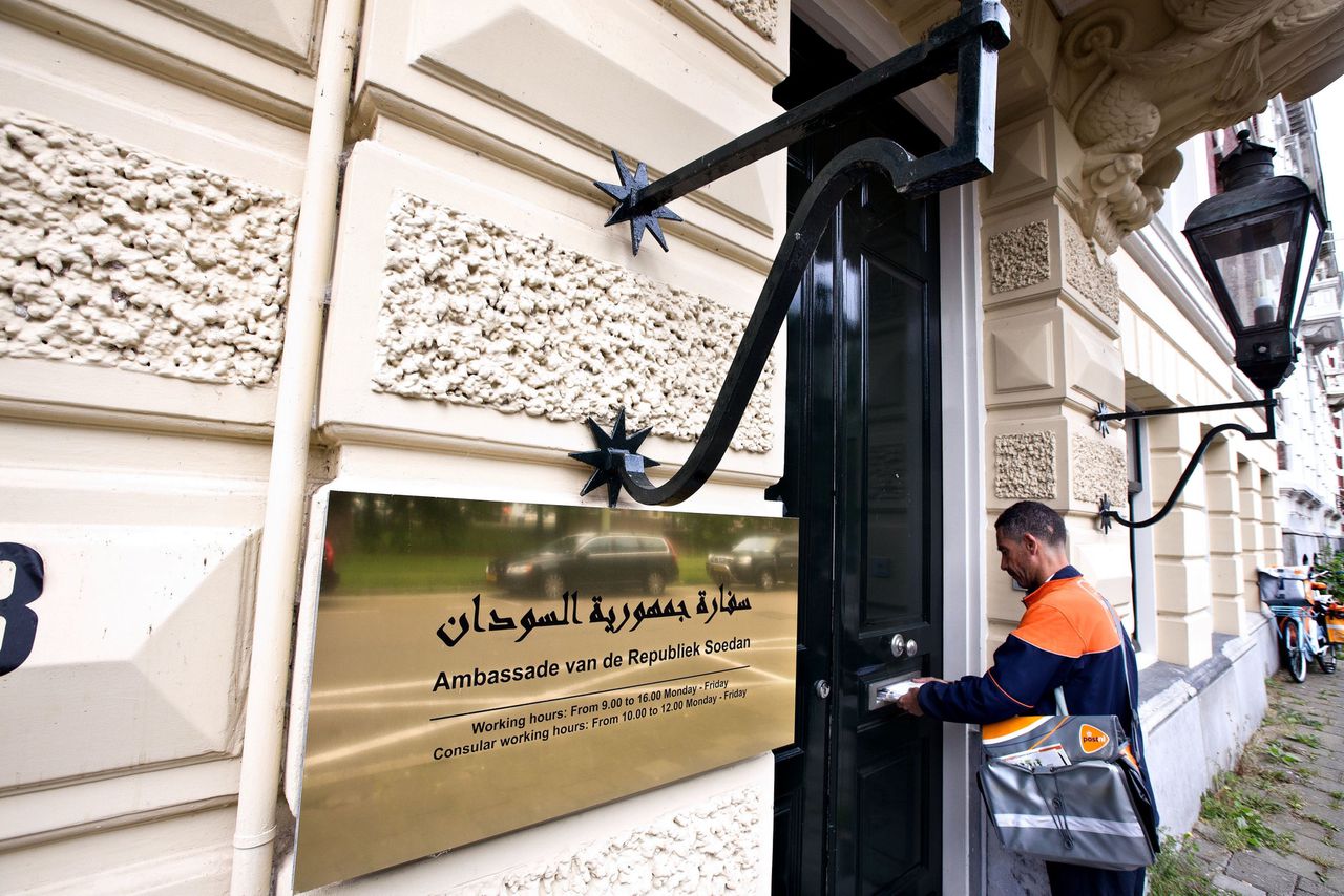 Een postbode brengt de post bij de ambassade van Soedan in Den Haag