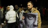 Een man houdt een foto van de vermoorde Russische oppositieleider Alexej Navalny vast  bij het monument voor slachtoffers van politieke repressie in de Litouwse hoofdstad Vilnius, waar de Russische oppositie in ballingschap afgelopen dagen bijeenkwam.