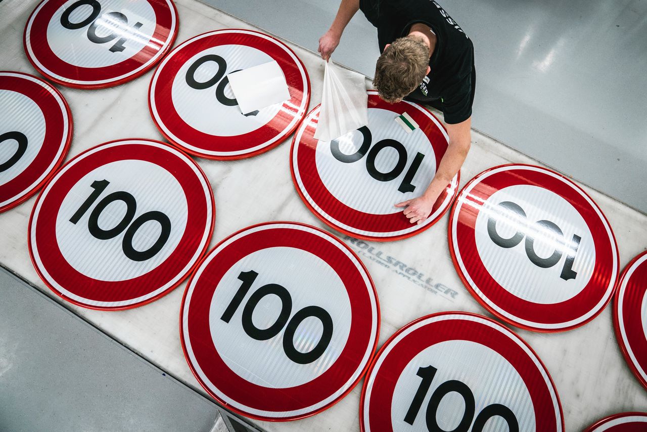Bij Visser print & sign in Assen worden nieuwe verkeersborden voor de maximale snelheid 100 km per uur beplakt.