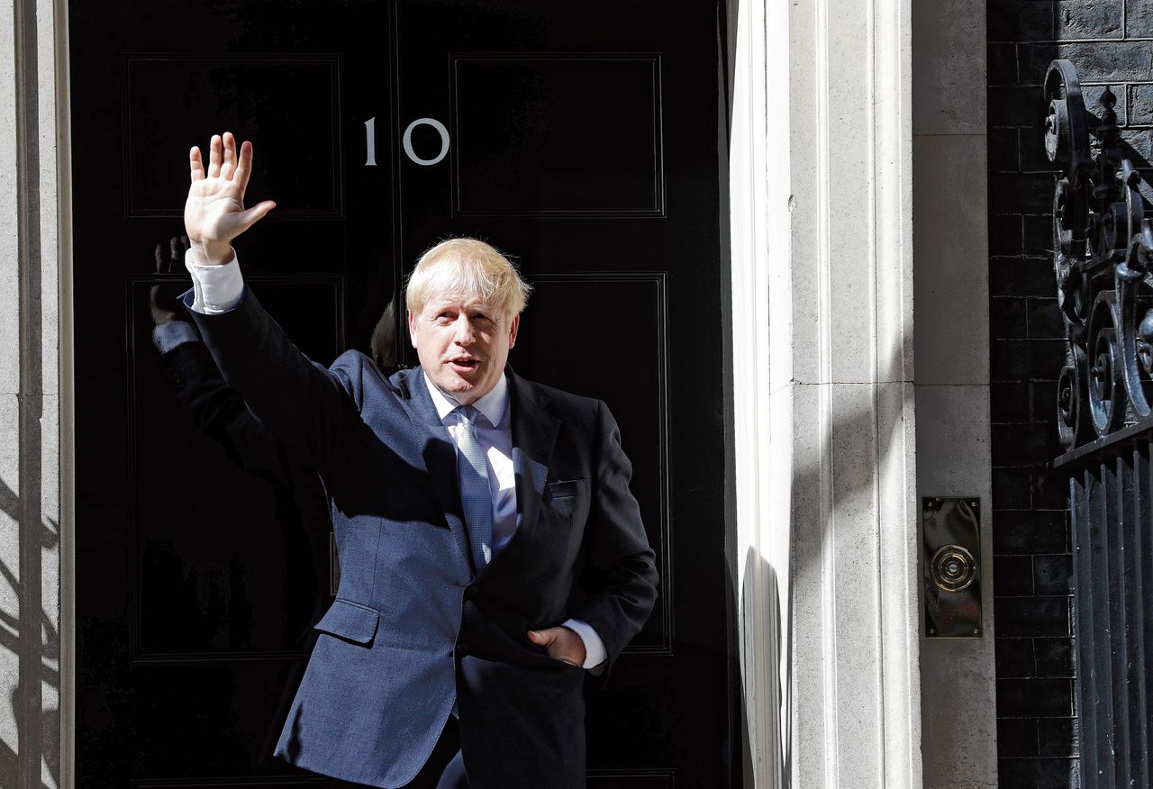 De nieuwe Britse premier Boris Johnson zwaaiend op de drempel van 10 Downing Street.