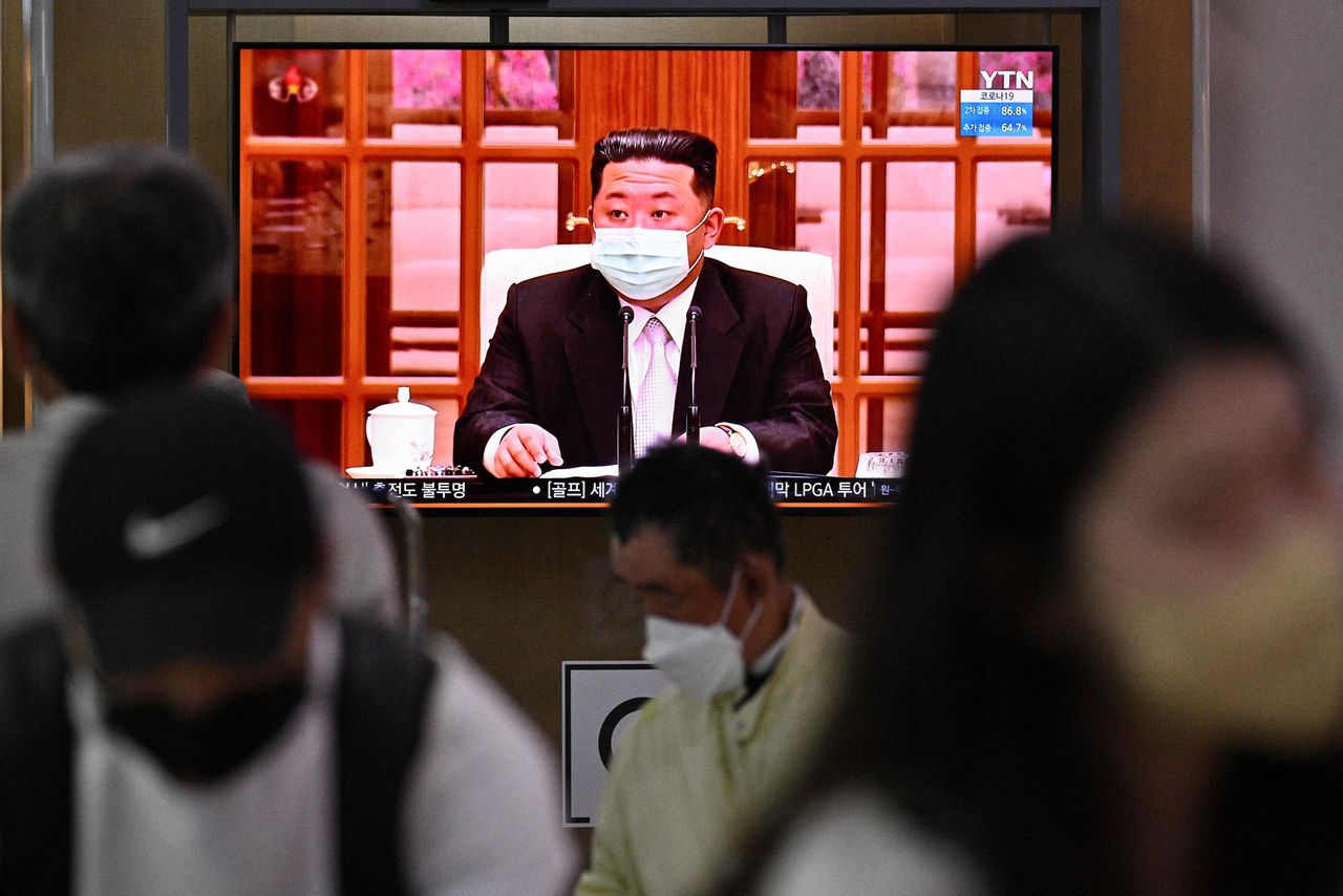 De Noord-Koreaanse leider Kim Jong-un draagt een mondkapje tijdens een aankondiging van een landelijke lockdown wegens de vaststelling van het coronavirus in het land, donderdag op een beeldscherm in de Zuid-Koreaanse hoofdstad Seoul.