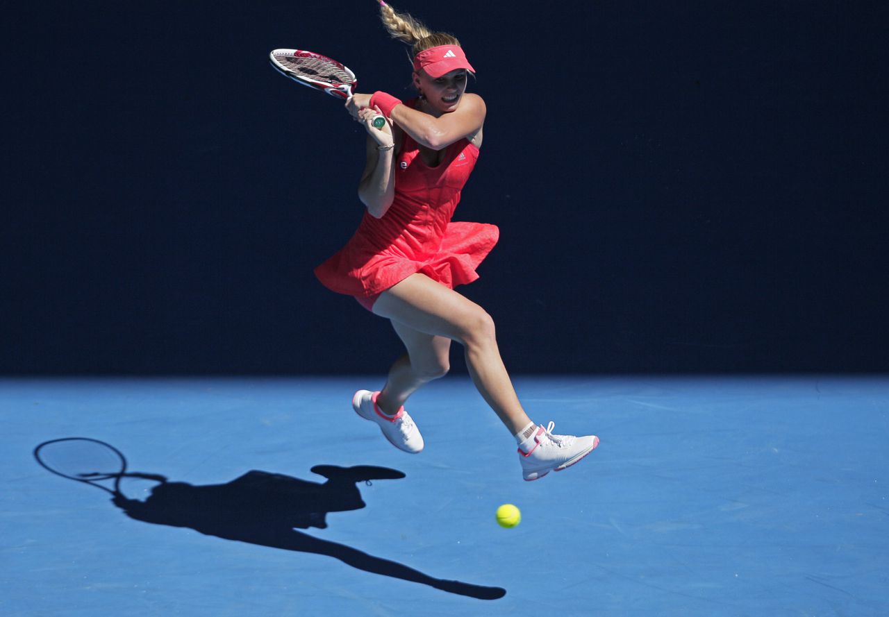Caroline Wozniacki of Denmark plays a shot against Kim Clijsters of Belgium during their quarterfinal at the Australian Open tennis championship, in Melbourne, Australia, Tuesday, Jan. 24, 2012.(AP Photo/John Donegan)