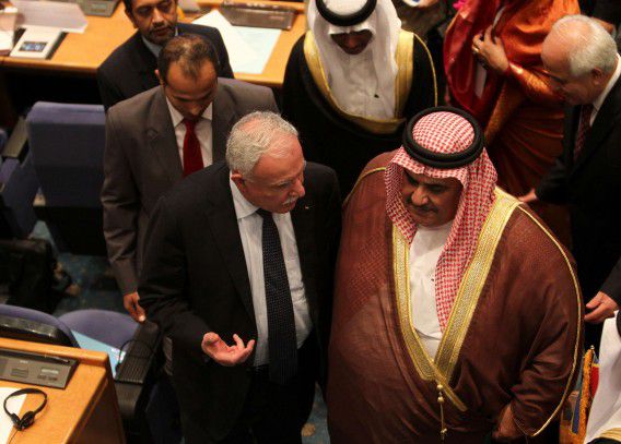 Palestinian Foreign Minister Riad al-Malki (L) chats with his Bahraini counterpart Sheikh Khaled bin Ahmed al-Khalifa (R) as they leave following the opening session of the Non-Aligned Movement (NAM) foreign ministers' meeting in Tehran on August 28, 2012. Condemnation of "unilateral" actions -- particularly sanctions on Iran and other nations -- and a demand for greater say in UN decision-making dominated talks in Tehran ahead of the Non-Aligned summit later this week. AFP PHOTO/BEHROUZ MEHRI