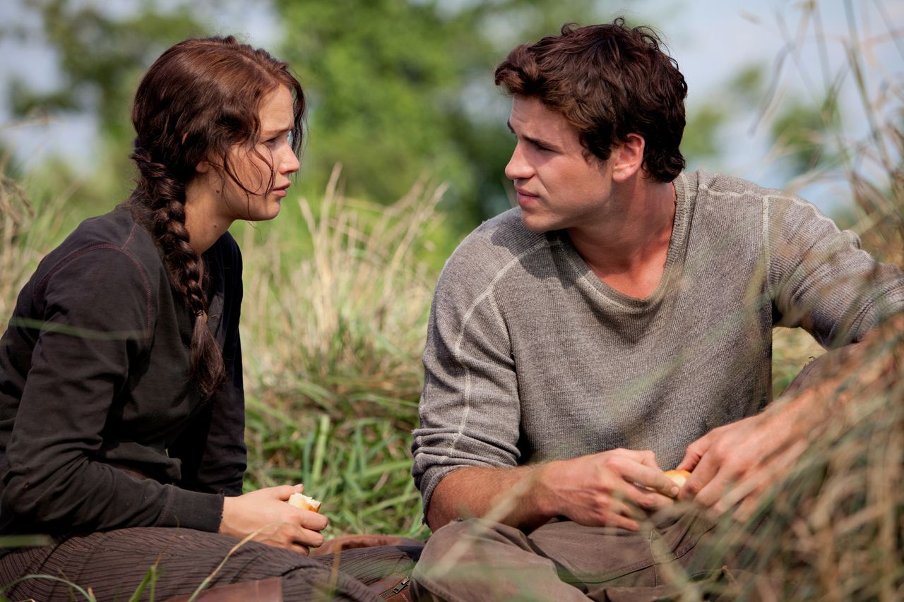 In this image released by Lionsgate, Jennifer Lawrence portrays Katniss Everdeen, left, and Liam Hemsworth portrays Gale Hawthorne in a scene from "The Hunger Games." (AP Photo/Lionsgate, Murray Close)