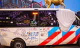 A police bus was sprayed with graffiti and paint during a demonstration.