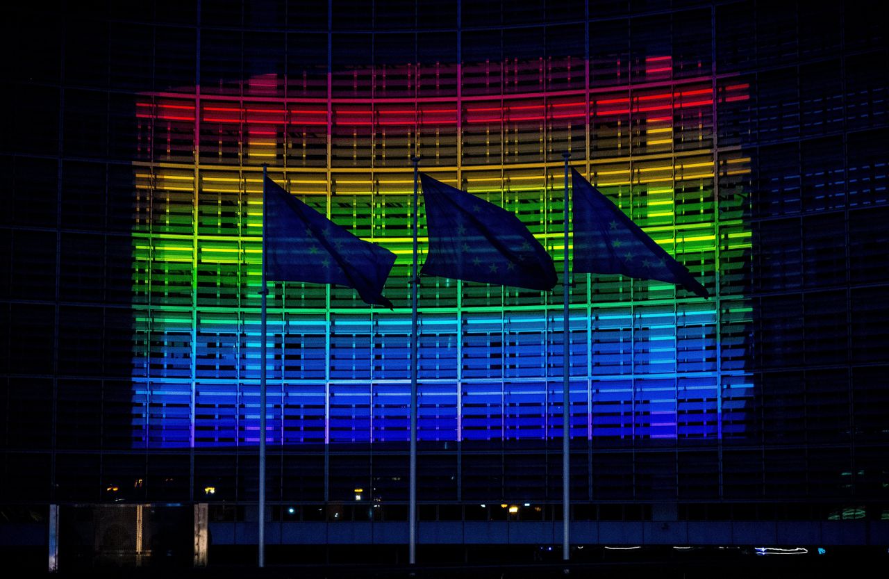 Het hoofdkantoor van de Europese Commissie in Brussel licht op in de kleuren van de regenboogvlag.
