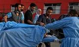 Medici take an injured tourist to a hospital in Anantnag on April 22 after shooters in the Kashmir controlled by India had opened fire on a group of tourists. 