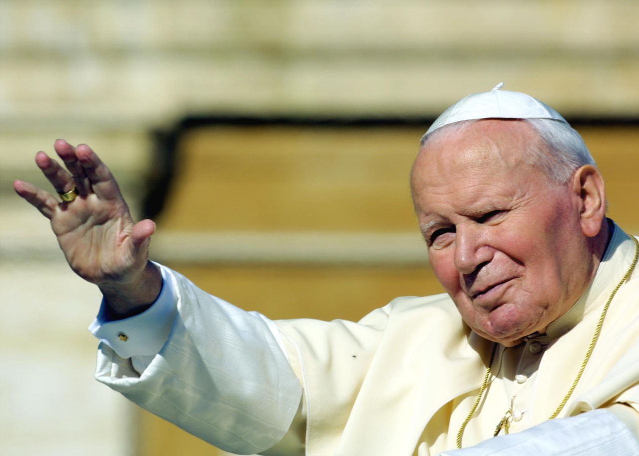 Paus Johannes Paulus II wuift naar gelovigen in Vaticaanstad. Hij overleed in 2005.