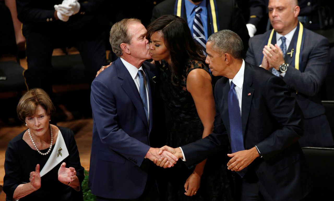Barack en Michelle Obama voorafgaand aan de toespraak dinsdag, samen met oud-president George W. Bush.