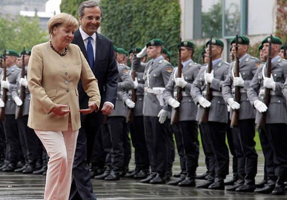 Name: 2012-08-24T105759Z_01_TOB07_RTRMDNP_3_EUROZONE-GERMANY-GREECE.JPG Caption: German Chancellor Angela Merkel (L) and Greek Prime Minister Antonis Samaras inspect the guard of honour during a welcome ceremony before talks in Berlin, August 24, 2012. The parliamentary leader of Merkel's ruling conservatives said on Friday, hours ahead of the chancellor's meeting with Samaras, that neither the time nor the content of Greece's rescue package can be renegotiated. REUTERS/ (GERMANY - Tags: POLITICS) IPTC Date: 10:57 24/08/12 Arrival Date: 12:58 24/08/12 Notes: