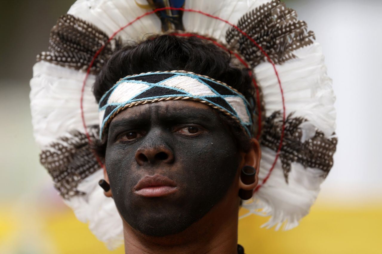 An indigenous man protests before the visit of FIFA Secretary General Jerome Valcke at Maracana Stadium in Rio de Janeiro November 26, 2012. An Indian community that lives in the unused Museum of Indians, next to the Maracana stadium, is fighting against the destruction of the Museum for the renovation and construction work for the World Cup. REUTERS/Ricardo Moraes (BRAZIL - Tags: SPORT SOCCER POLITICS CIVIL UNREST HEADSHOT)