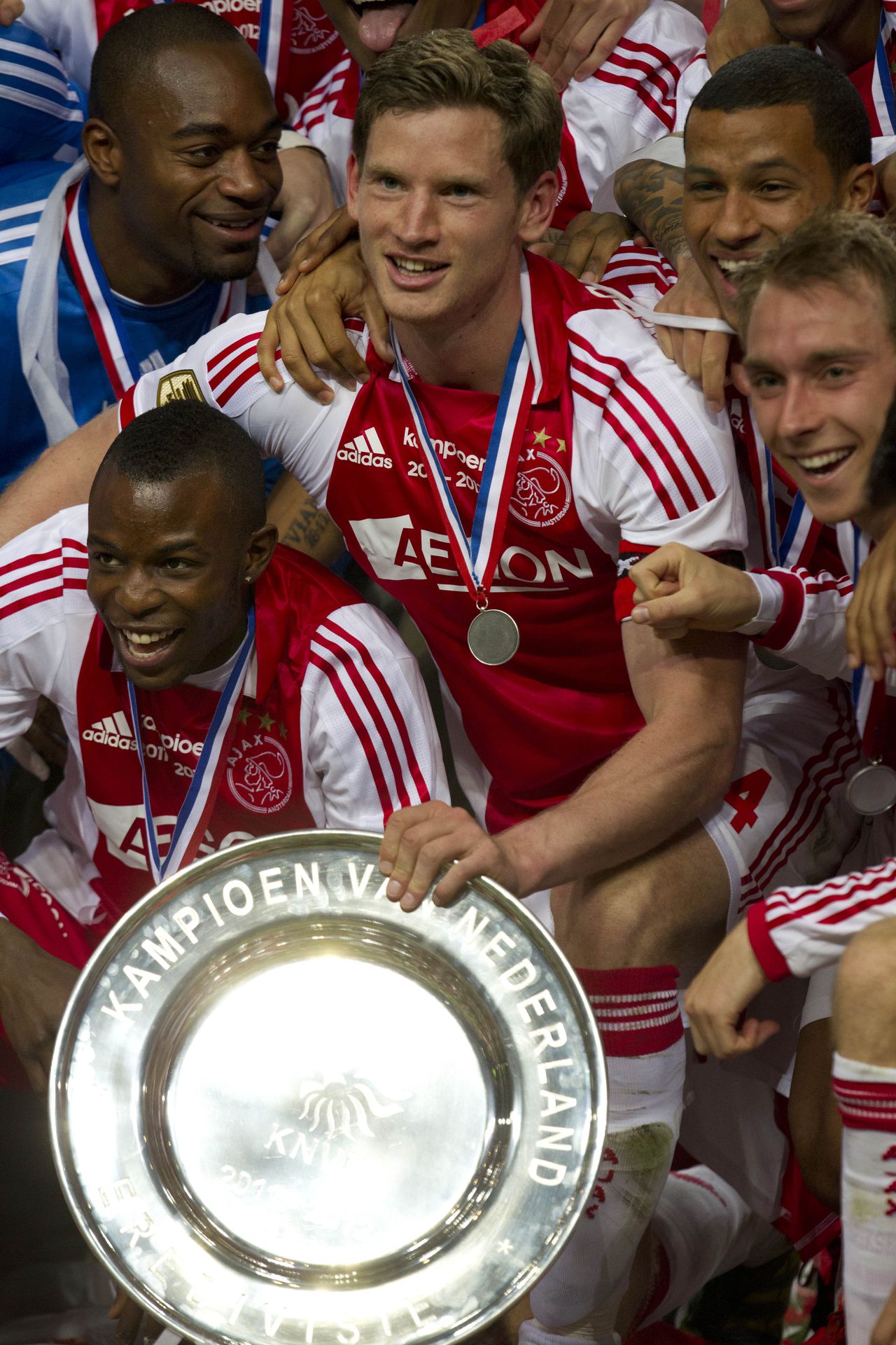 Ajax soccer players with captain Jan Vertonghen, center holding the trophy, celebrate clinching the Dutch Premier League title after defeating VVV Venlo with a 2-0 score at ArenA stadium in Amsterdam, Netherlands, Wednesday May 2, 2012. (AP Photo/Peter Dejong)