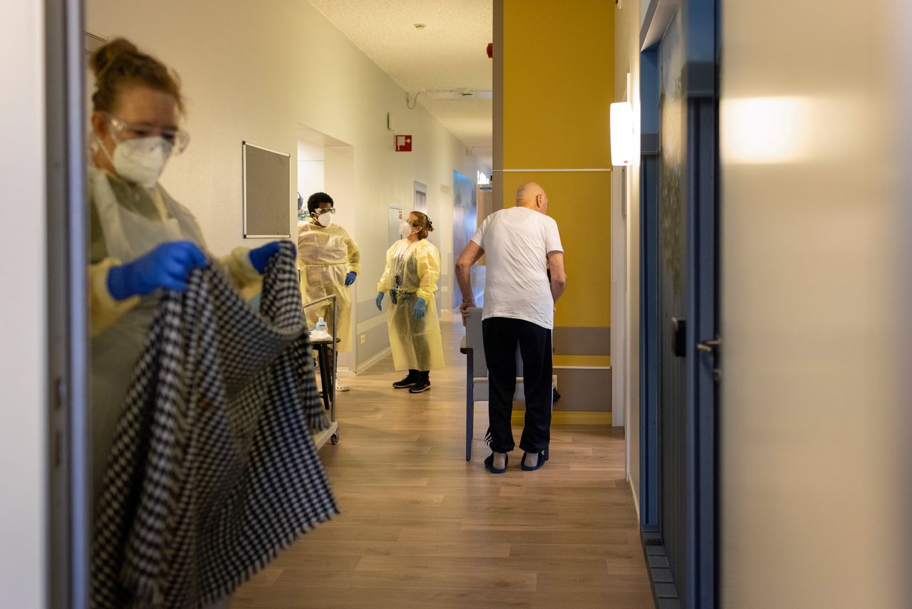 Medewerkers en een bewoner op de gang in verpleeghuis Berkenstede in Diemen (Noord-Holland).