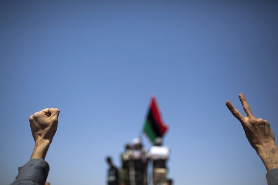A man makes the V-sign during the funeral of rebel fighter Hussein Saad Al Awamia, in Benghazi, Libya, Tuesday, May 10, 2011. Al Awamia was killed Monday during fighting against Moammar Gadhafi forces. NATO warplanes struck a command center in Tripoli early Tuesday in the heaviest bombing of the Libyan capital in weeks, while rebels capitalizing on other NATO air strikes reported battlefront gains that could ease the siege of the port city of Misrata. (AP Photo/Rodrigo Abd)