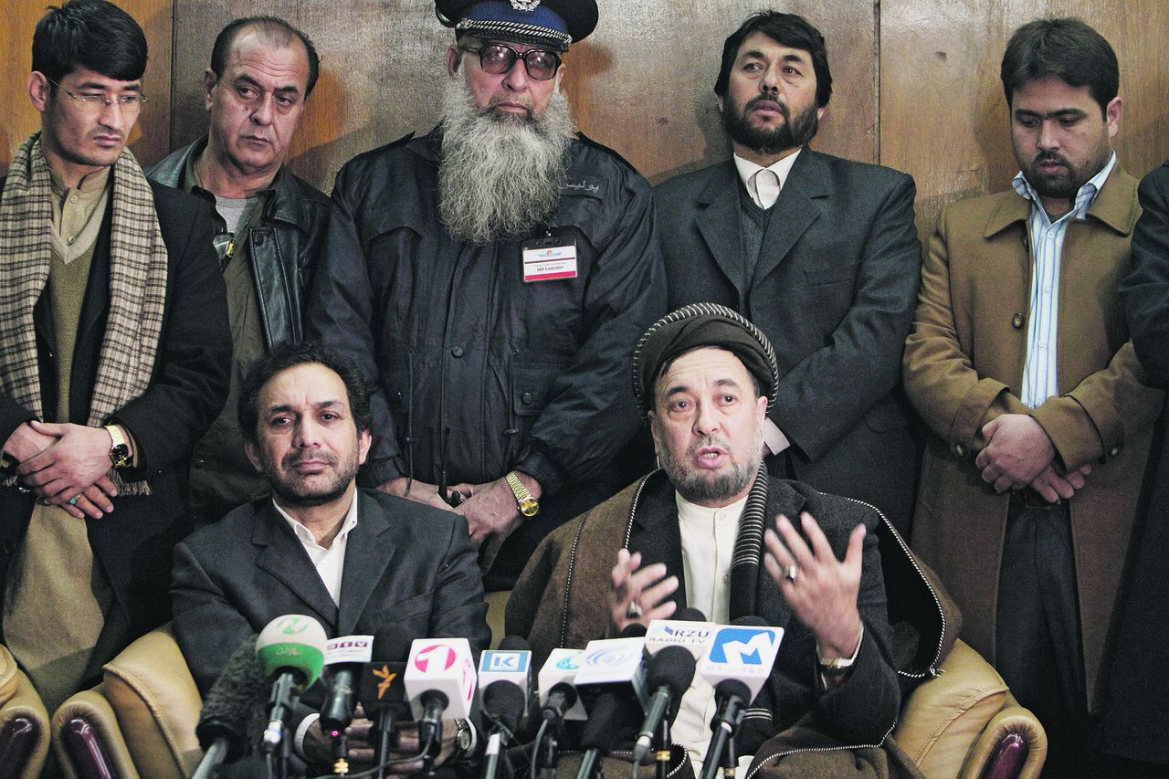 Ethnic Hazara leader Mohammad Muhaqiq, right, speaks during a press conference as prominent Afghan opposition leader Ahmad Zia Masood, left, listens after returning from Germany at the airport in Kabul, Afghanistan, Friday, Jan. 13, 2012. "If the government is going to start a peace process, then we should also be in this process because we also represent part of the nation," he said. "If the peace process is not clear, then peace cannot be successful." (AP Photo/Musadeq Sadeq)